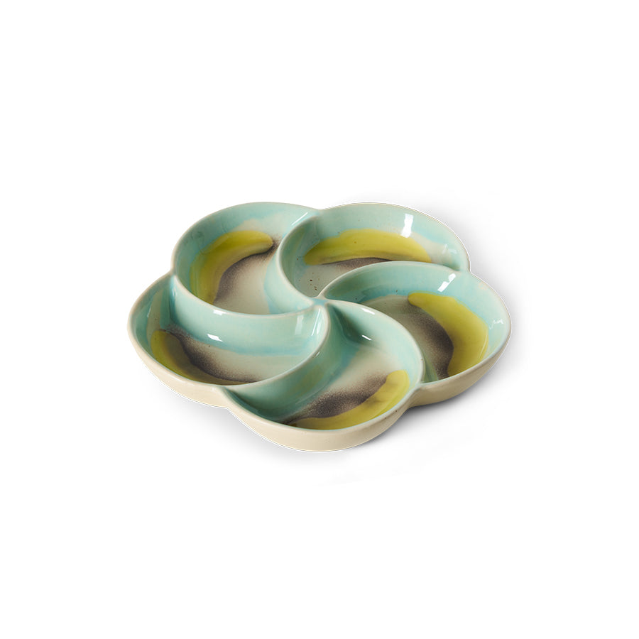 Decorative ceramic plate with wavy design on a white background