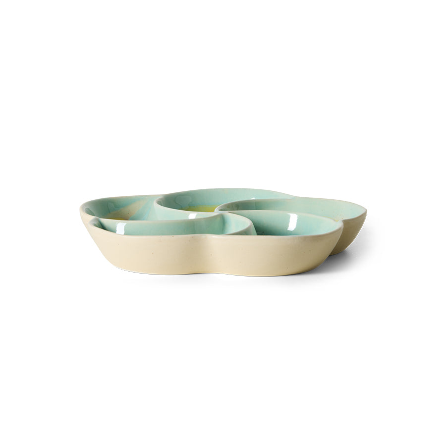 Set of three ceramic bowls in pastel green and beige on a white background