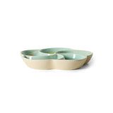 Set of three ceramic bowls in pastel green and beige on a white background